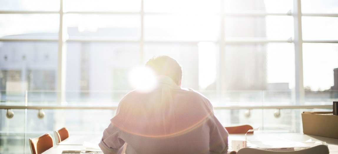 Photo of a man in a conference room.